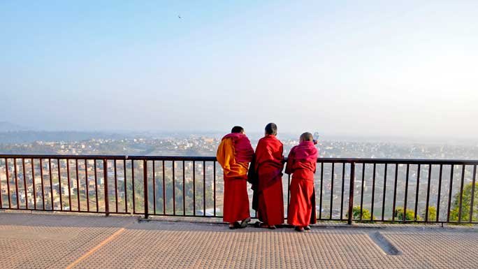 Young monks looking over at the Kathmandu Valley in Kapan Monastery, Nepal. 