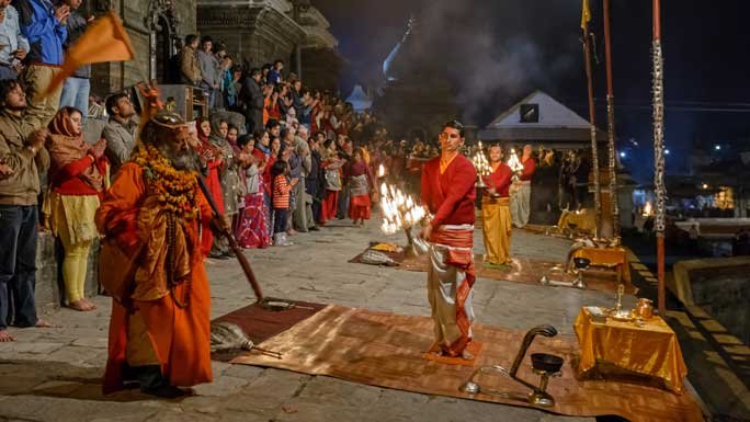 Devotees at the evening Aarati by the Bagmati River at Pashupatinath Temple, Kathmandu, Nepal. 
