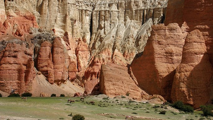 The rugged desert terrain of Upper Mustang is complimented by splashes of green vegetation for agriculture and pastures.